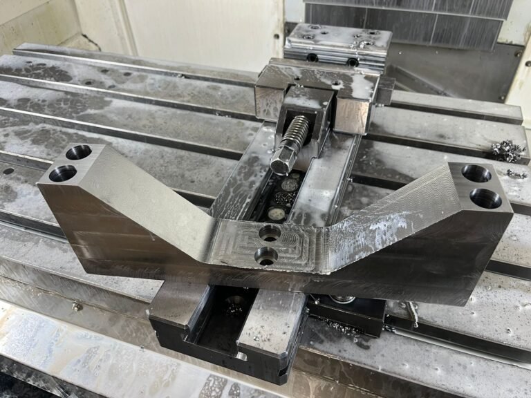 Component clamped in a machining fixture on the machine table