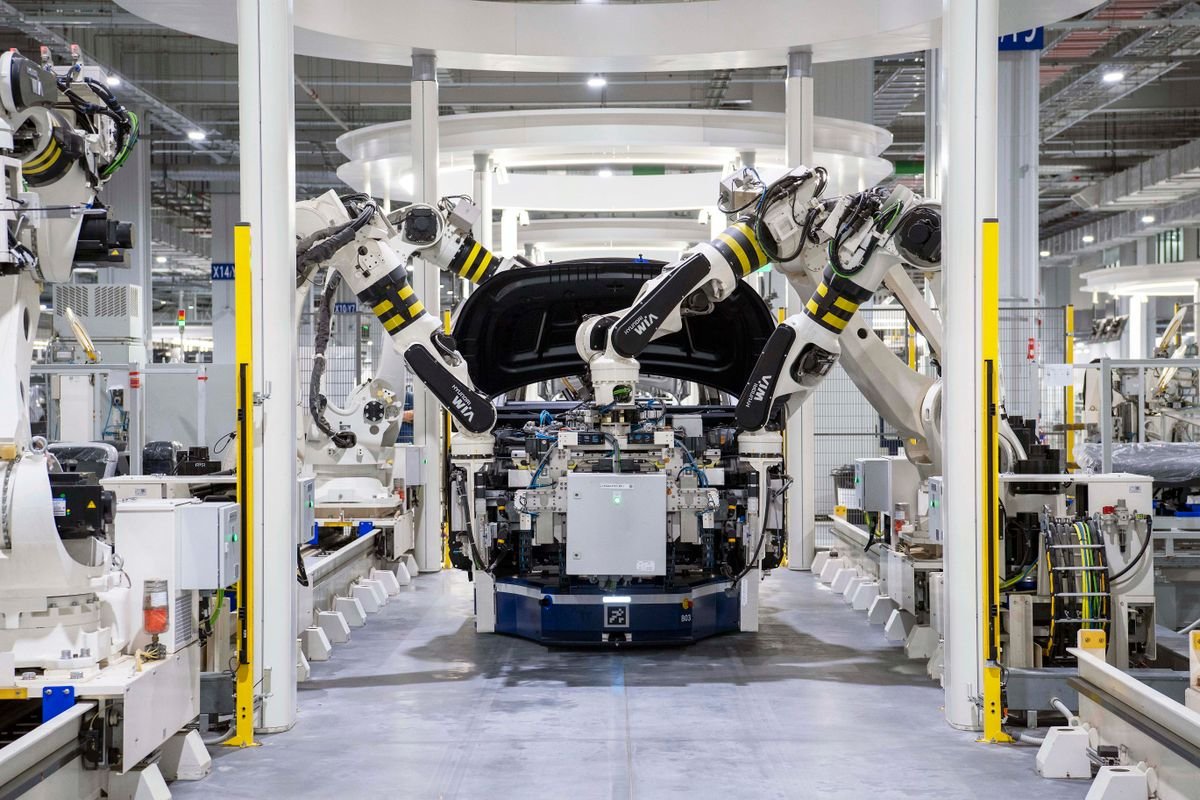 Robotic arms assembling a car body on an automotive production line